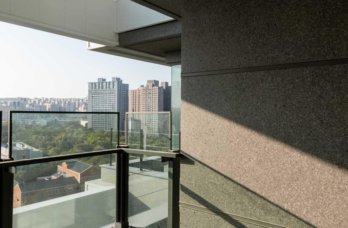 Look out from the higher floor, the scene and campus are visible. The warm sunshine reflected on the granite texture wall with ADD STONE Granite Texture Faux-Stone coating